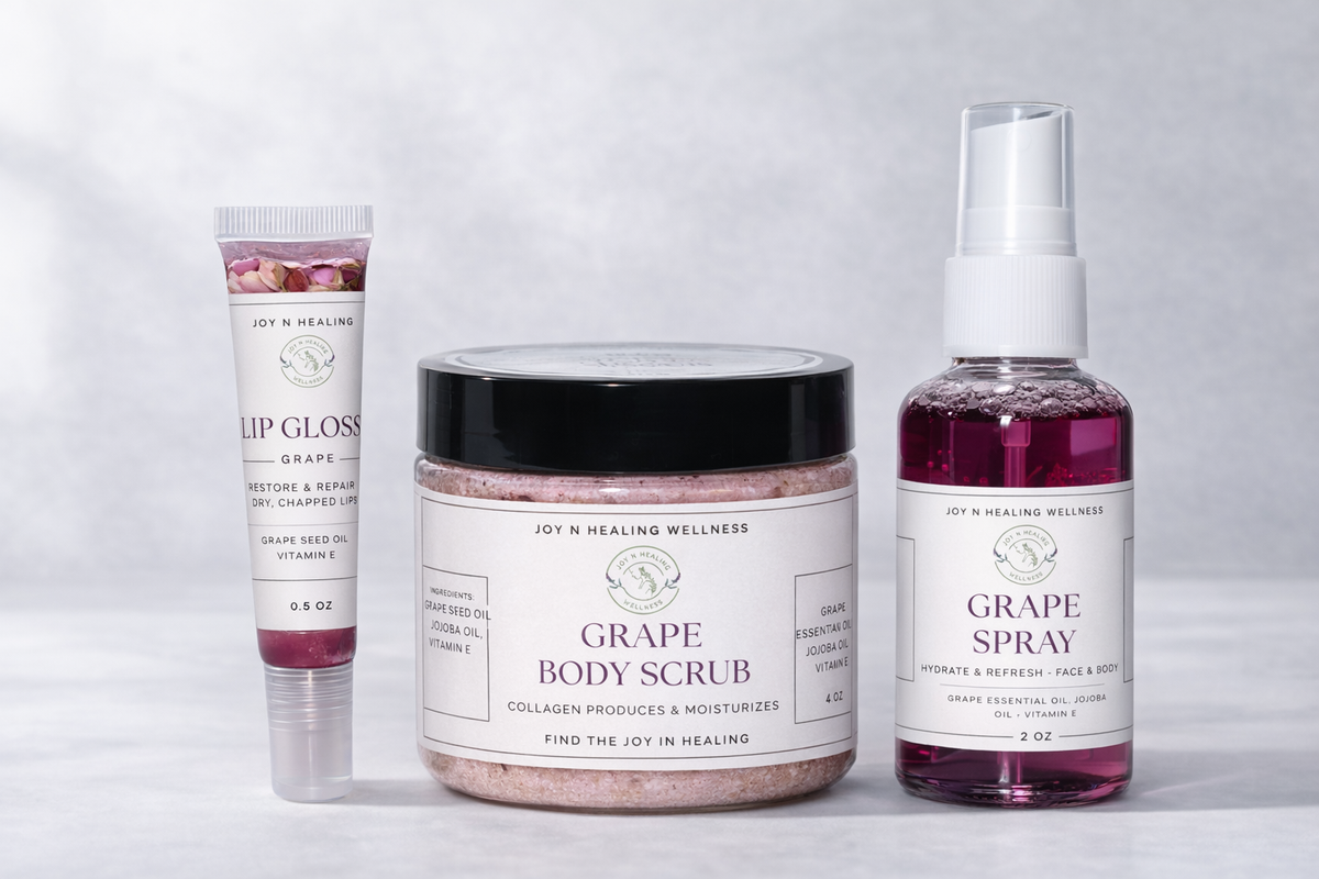 Collection of grape-themed skincare products including lip gloss, body scrub, and spray on a light gray background.