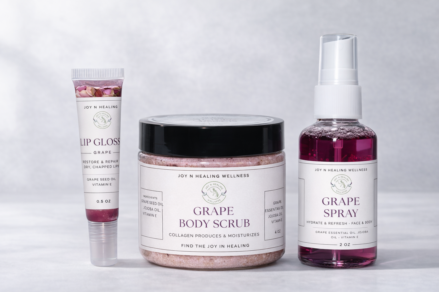 Collection of grape-themed skincare products including lip gloss, body scrub, and spray on a light gray background.