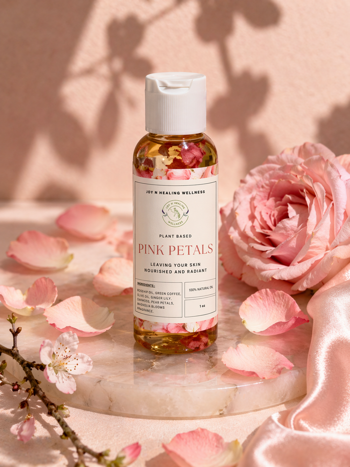 Bottle of 'Pink Petals' product with pink roses and petals on a marble surface
