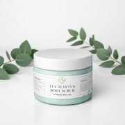 Jar of Eucalyptus Body Scrub with eucalyptus leaves on a white background